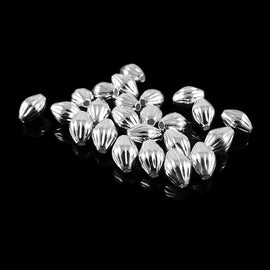 Metal beads: 7 mm x 5 mm corrugated bicone, silver plated brass, 1.2 mm bead hole, 25 beads
