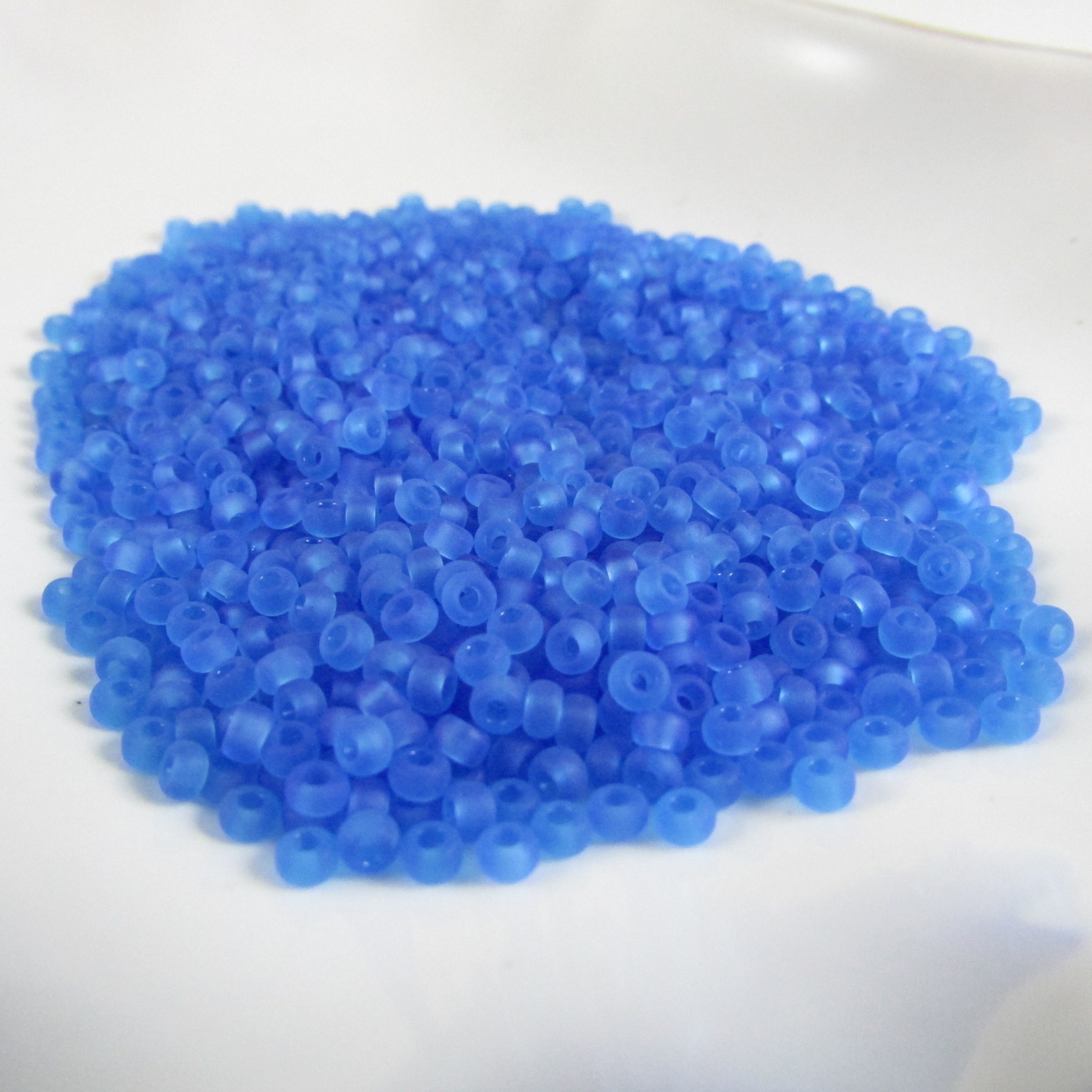 Size 8/0 transparent light blue Dyna-Mites glass seed beads, 20gm